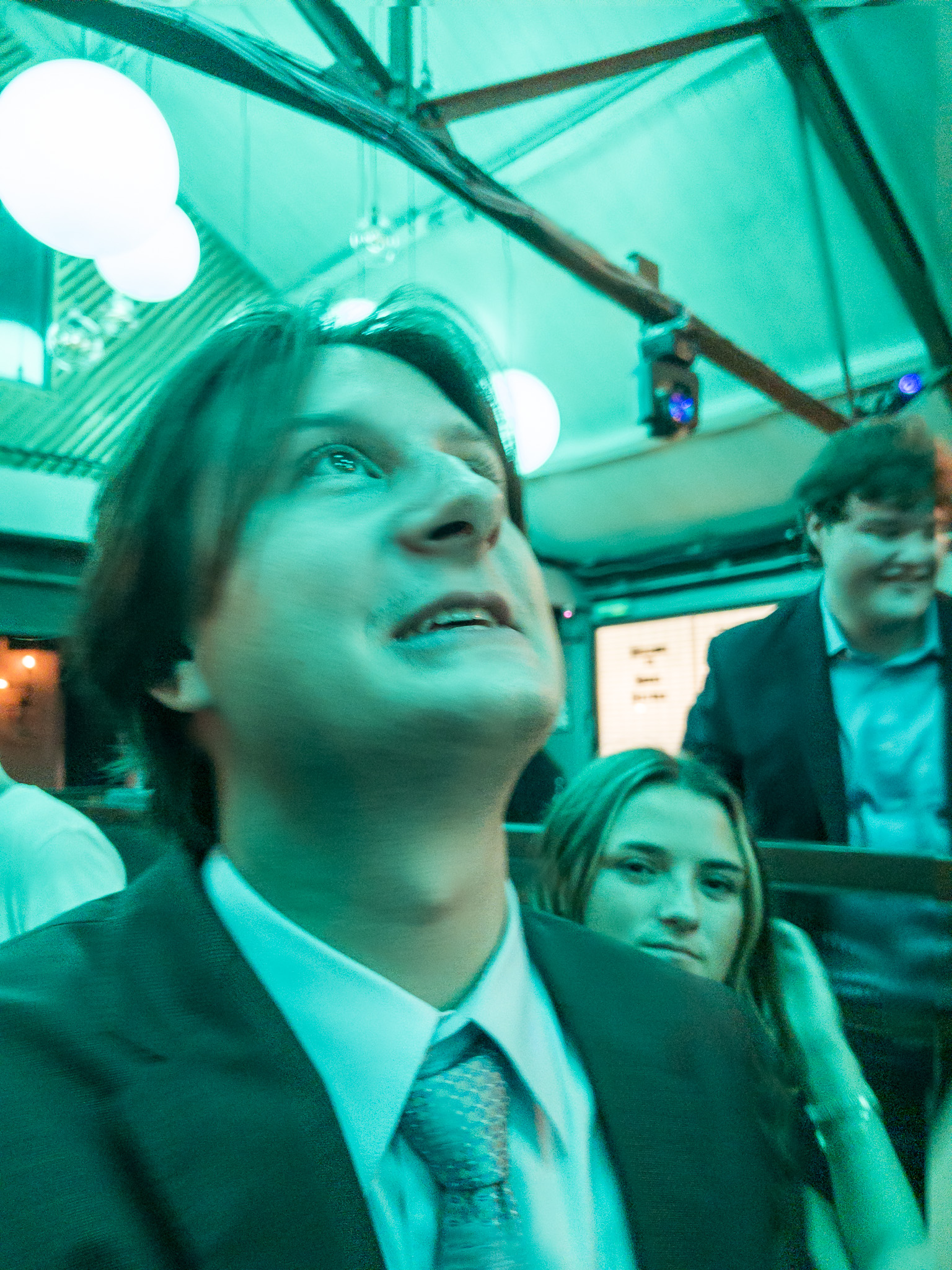 man in suit stares into club lights