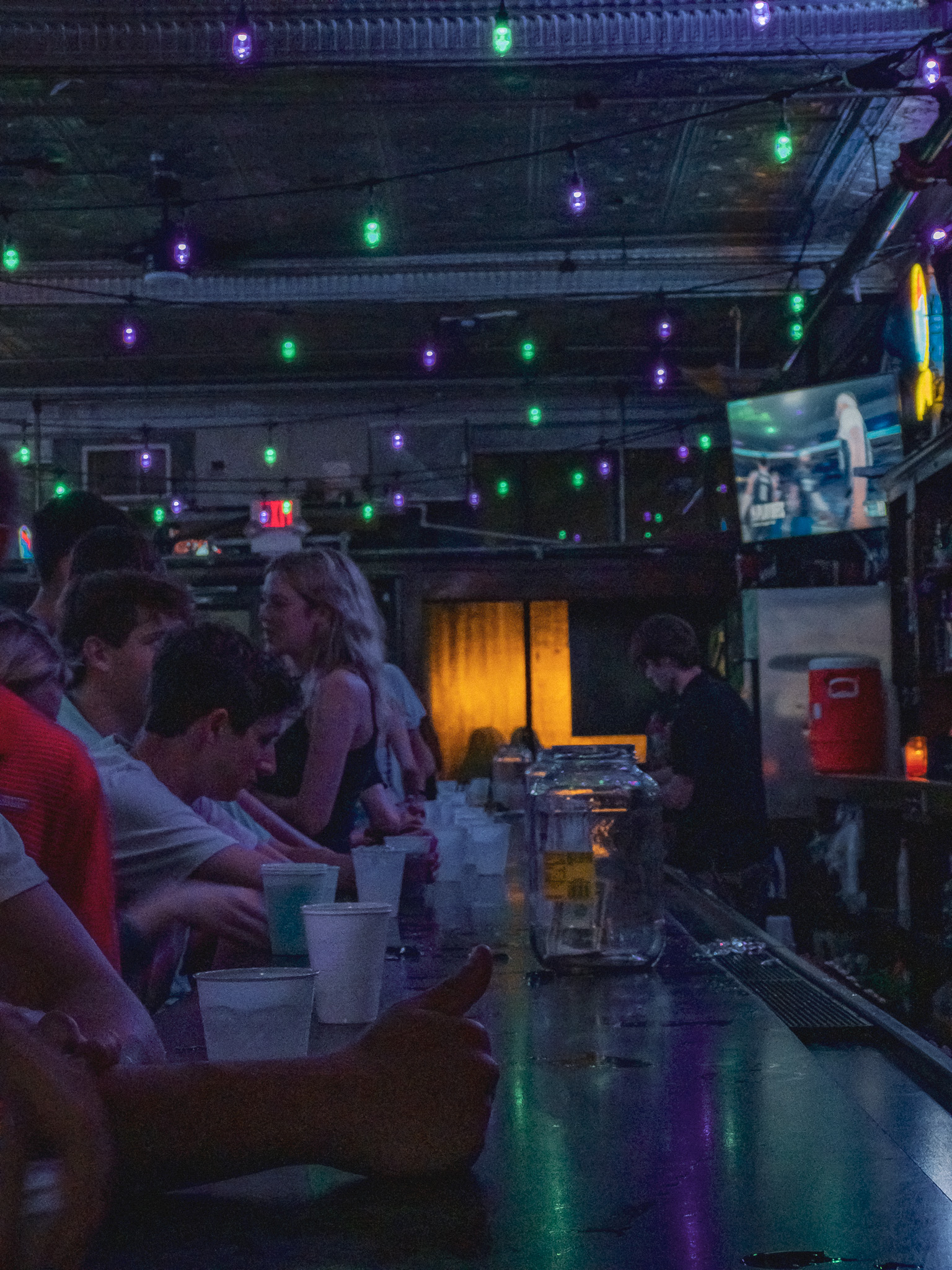 a person gives a thumbs up at a bar