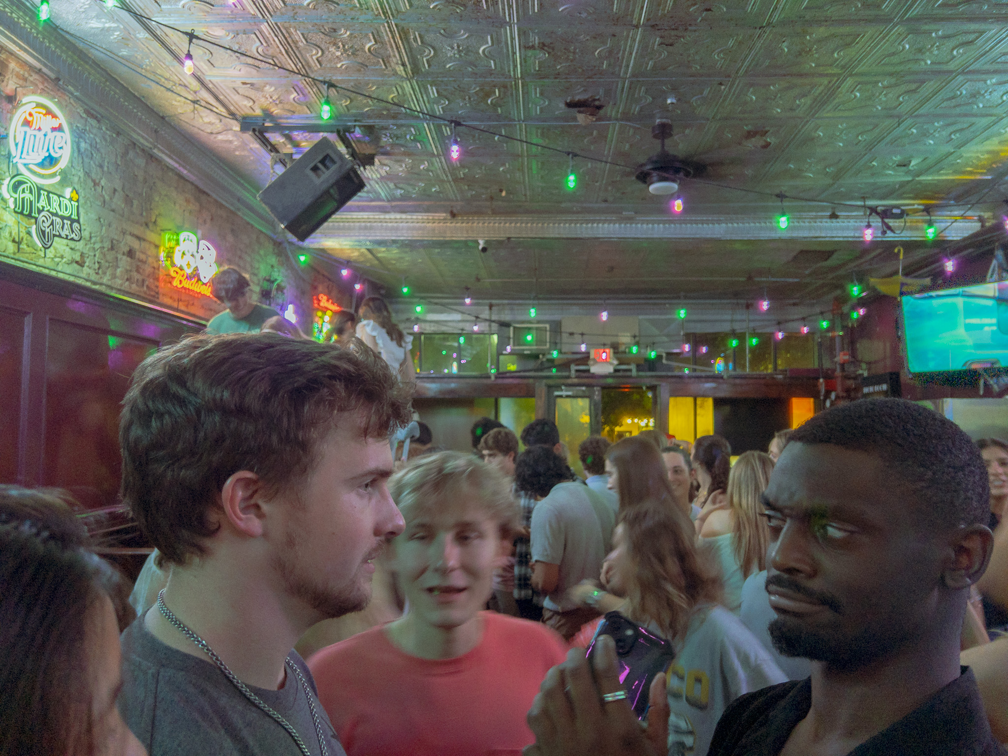 a man is confused talking to someone in a bar