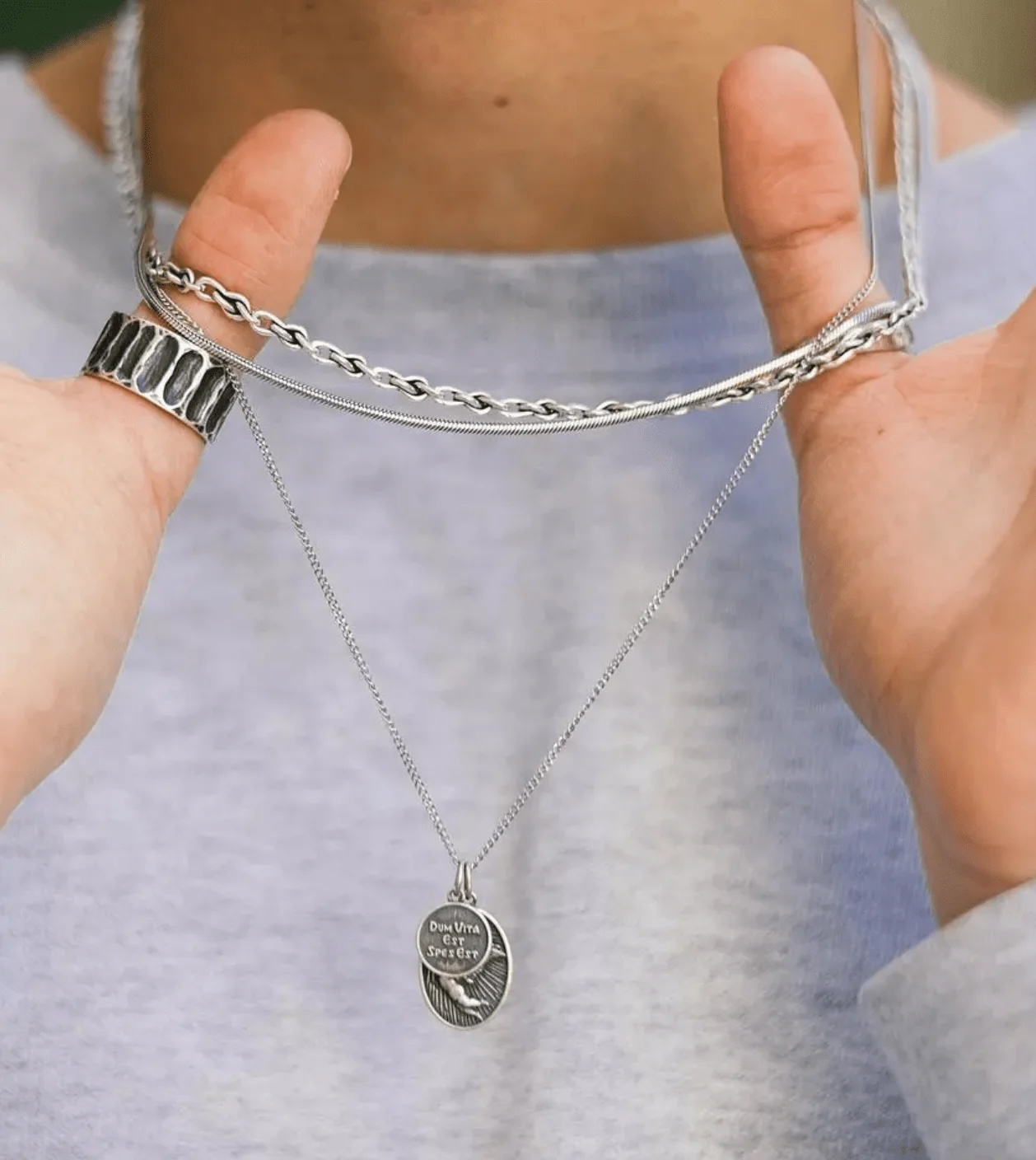 Model wearing silver necklace and ring