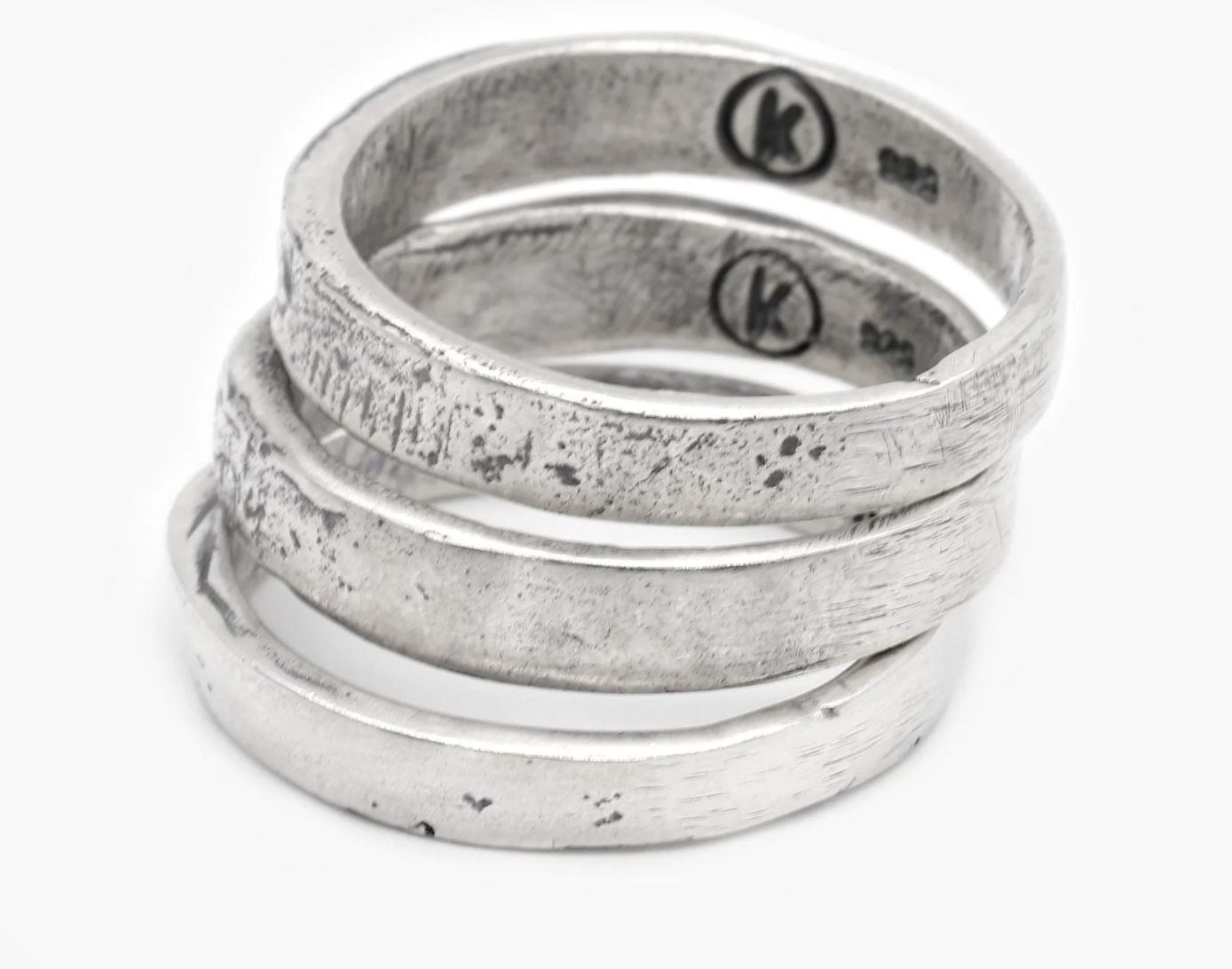 A stack of three silver rings from behind