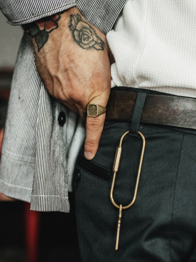 Man wearing gold ring on pointer finger